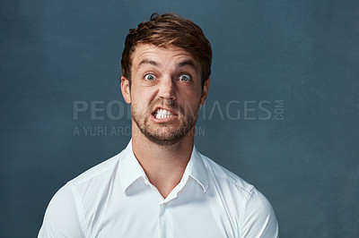 Buy stock photo Face, angry and man in studio, mad or anxiety of journalist with fail of assignment in newsroom for story. Blue background, mockup and stress of reporter with teeth, frustrated and portrait of person