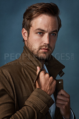 Buy stock photo Fashion, serious and man with thinking in studio for edgy style, confidence or satisfaction. Designer jacket, relax and person with idea in wonder on blue background for cool outfit, pride or clothes