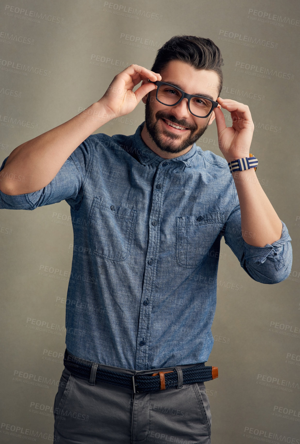 Buy stock photo Studio portrait of a handsome young man posing against a grey background