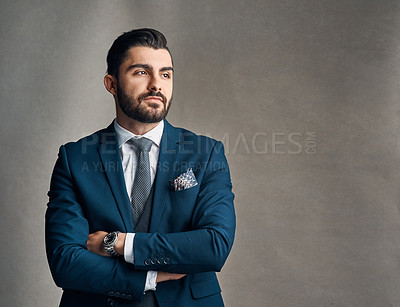 Buy stock photo Studio shot of a stylishly dressed young businessman envisioning success against a grey background