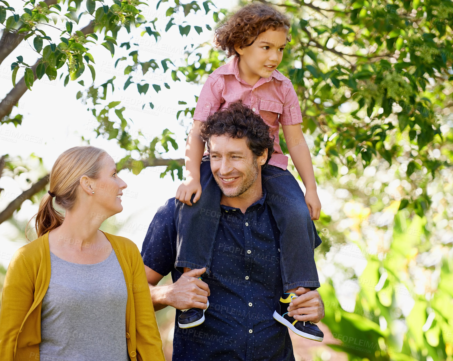 Buy stock photo Family, parents and child in nature for fun, happy care and bonding with children smile in park. Couple, outside walking  and kid together in summer, love and relationship for growth development