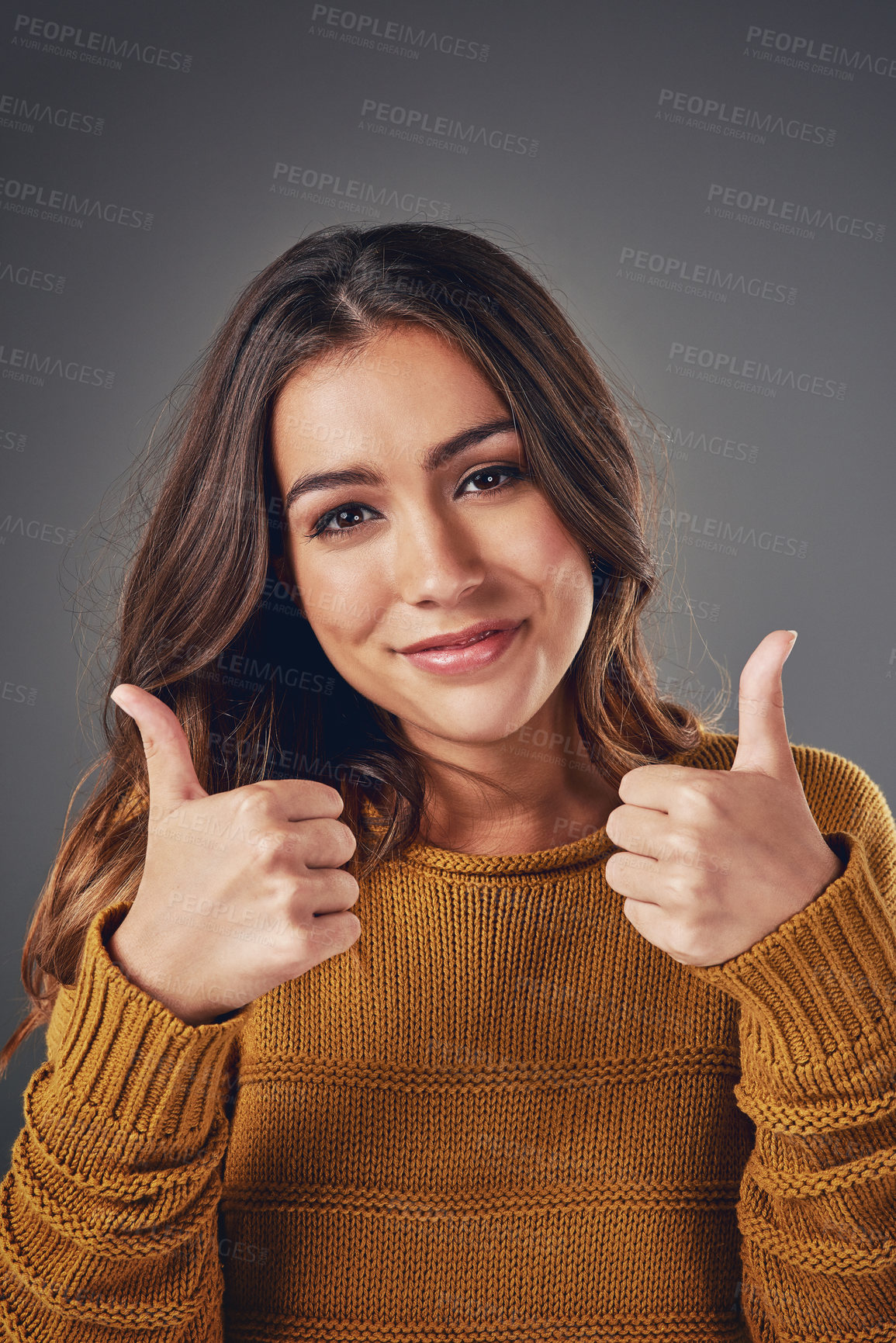 Buy stock photo Woman, portrait smile and thumbs up with fashion for winter, style inspiration and agreement in studio. Girl, happy and like emoji for organic fabric, designer clothes and thanks by gray background