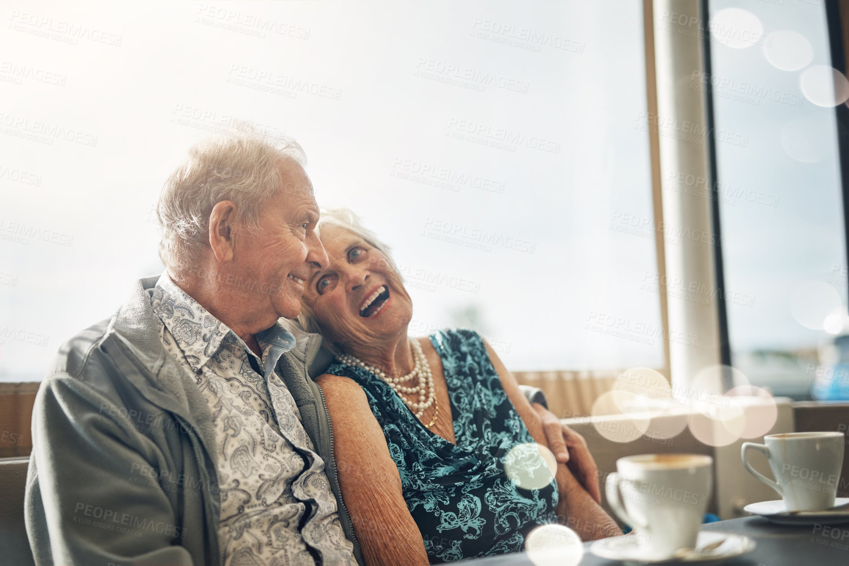 Buy stock photo Happy, elderly couple and laughing on coffee date in restaurant for bonding, comedy and funny joke in retirement. Smile, senior man and woman with bokeh and morning espresso for relax and humour