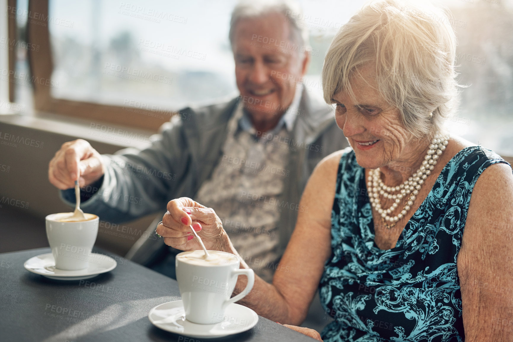 Buy stock photo Date, bonding and senior couple with coffee, smile and joy in cafe, together and celebrating love. Retirement, happy and elderly people with commitment in restaurant and drink for anniversary
