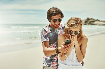 Buy stock photo Cropped shot of a young man proposing to his girlfriend on the beach