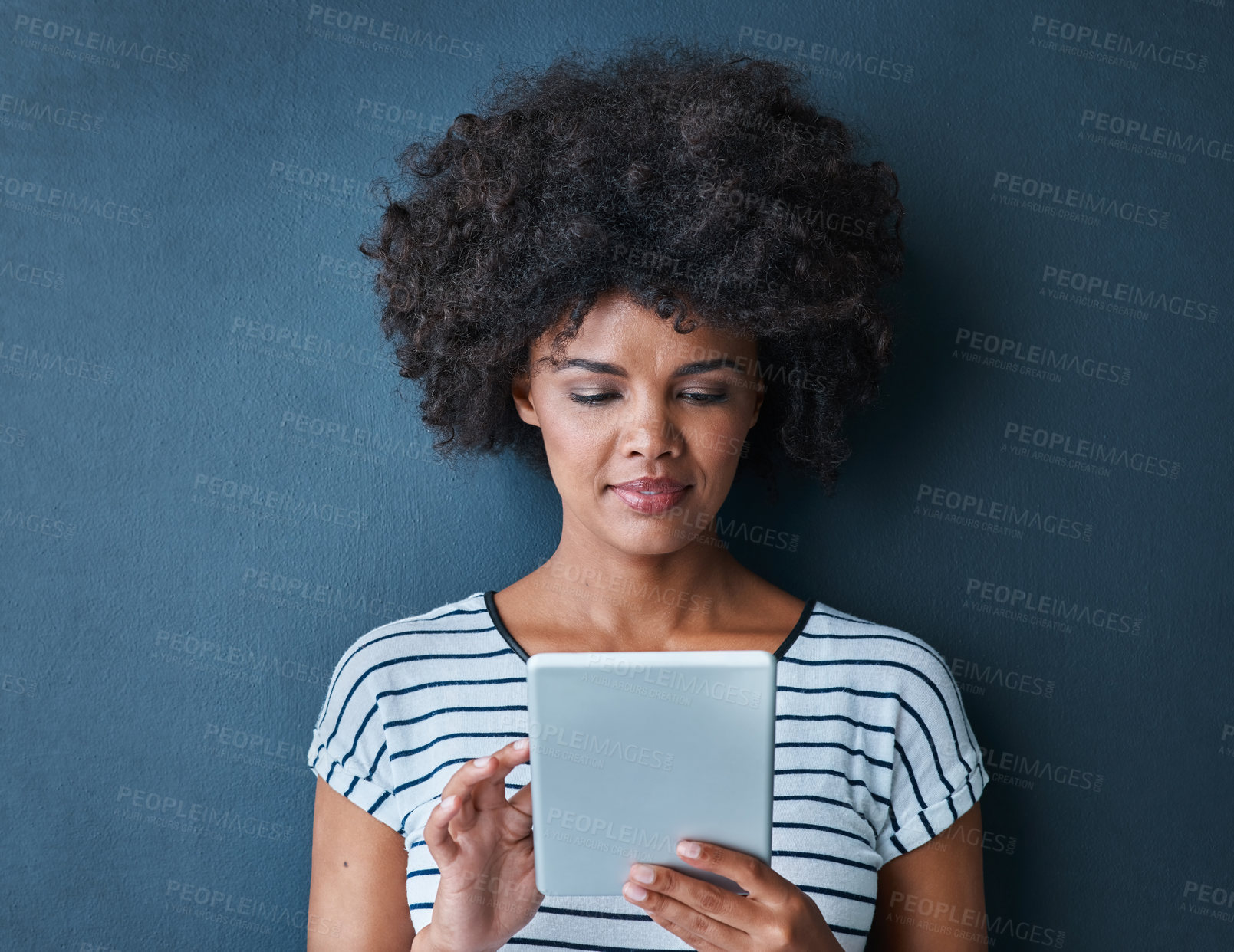 Buy stock photo African woman, student and tablet in studio for reading, thinking or study on app for test by blue background. Person, girl and click on digital touchscreen, online course or elearning for education