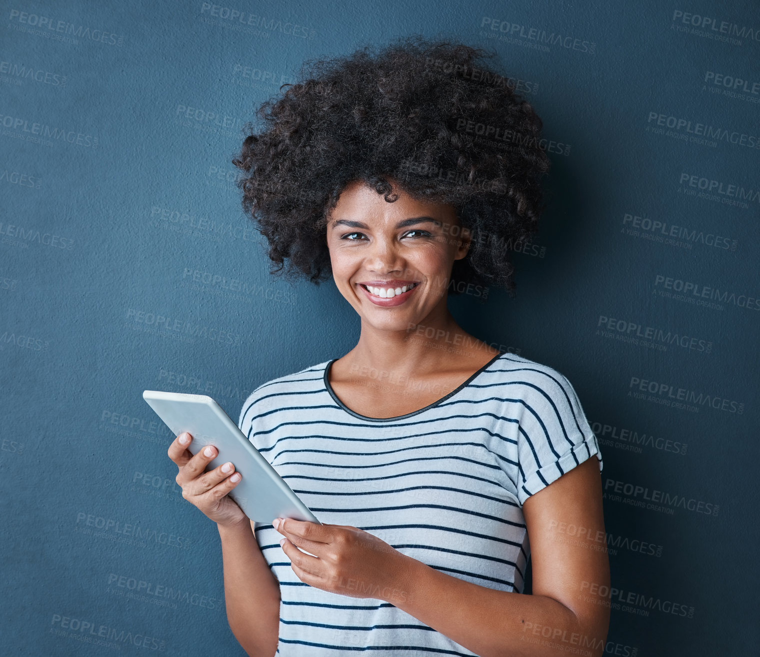 Buy stock photo Studio, black woman and digital tablet in portrait to chat, connect and social media with smile. Blue background, girl and tech for networking, scrolling and typing or read by online application