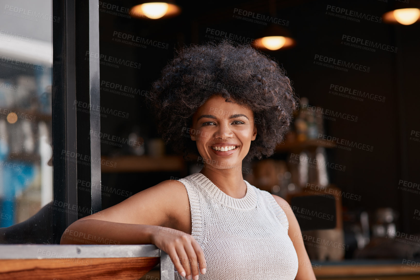 Buy stock photo Portrait of a confident young business owner posing in the doorway of her coffee shop