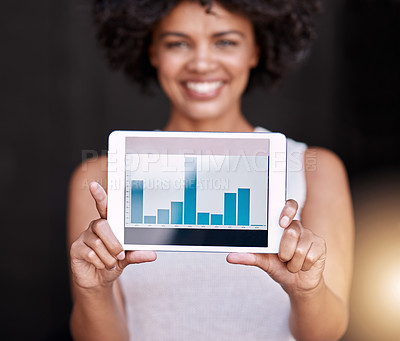 Buy stock photo Portrait of a smiling young business owner holding up a tablet displaying graphs