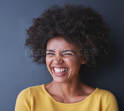 Buy stock photo Laughing, black woman and portrait in studio for beauty with happiness, freedom or wellness mockup, Happy, face and natural African hair care, cosmetics and smile for dermatology on grey background