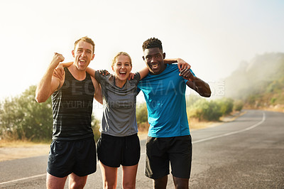 Buy stock photo Portrait of a group of sporty young people celebrating after a workout outside