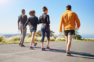 Buy stock photo Rear view shot of a fitness group out for a run together