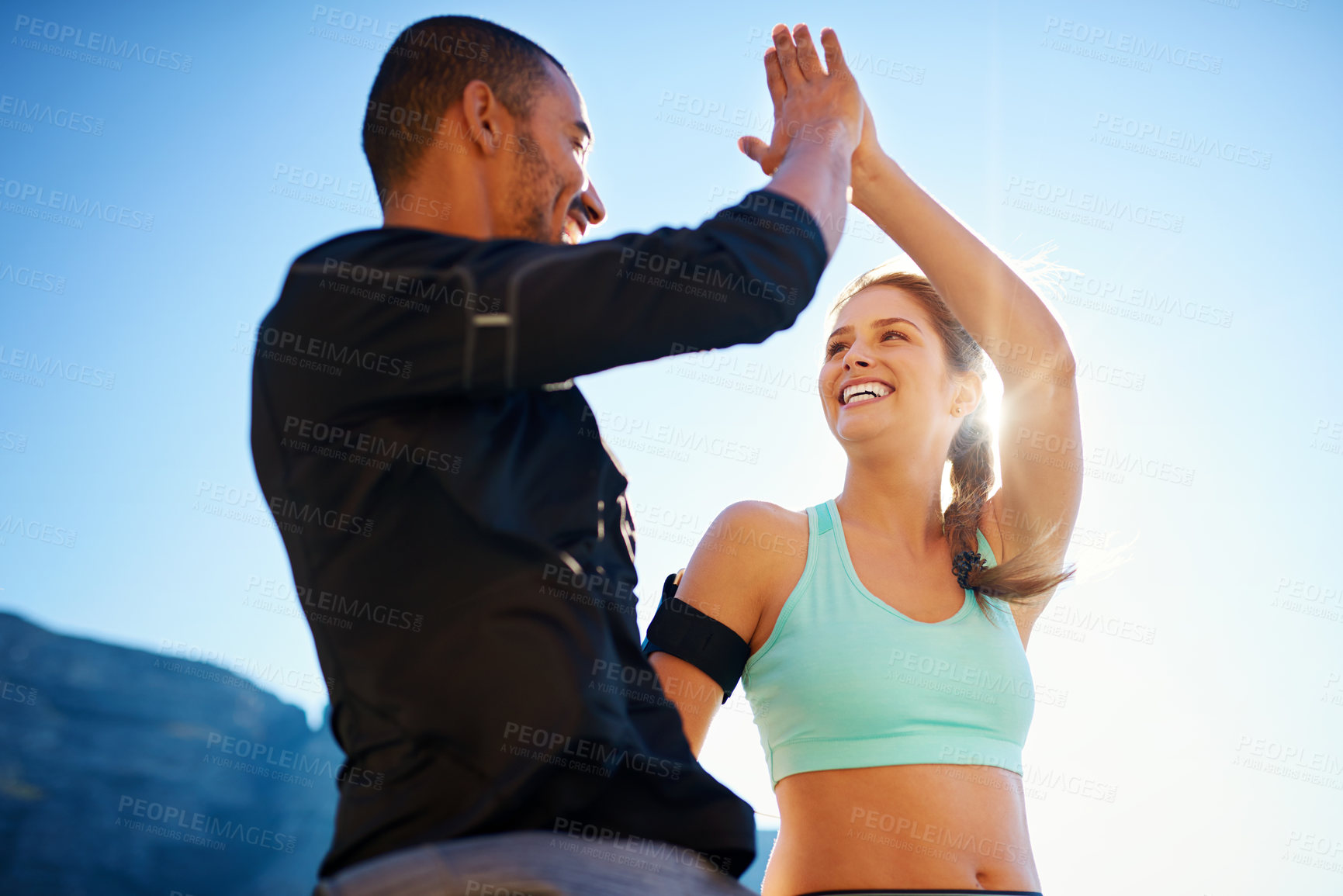 Buy stock photo High five, man and woman on mountain for fitness, teamwork and confidence in sports training together. Smile, nature and personal trainer with athlete, celebration and success in outdoor workout