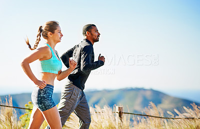 Buy stock photo Cropped shot of a sporty young couple out for a run together