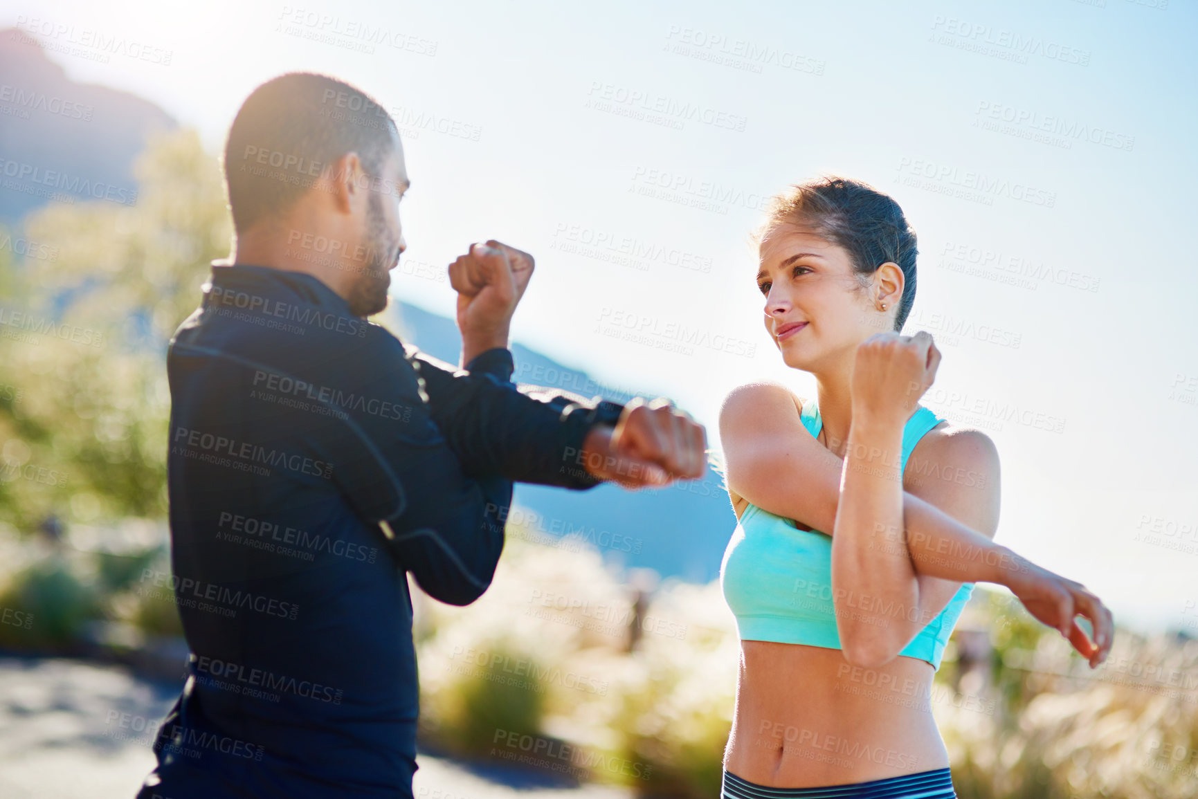 Buy stock photo Man, woman and outdoor stretching for exercise warm up or arm mobility on mountain path, coach or running. Personal trainer, client and nature workout for training support or friends, cardio or sport