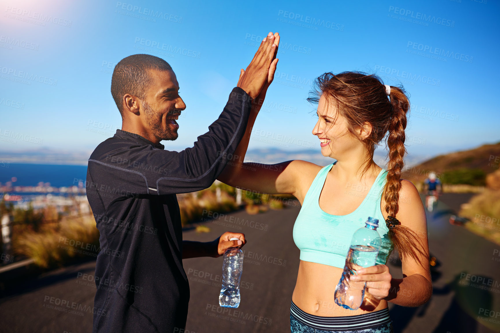 Buy stock photo High five, man and woman on mountain for exercise, teamwork and confidence in fitness training together. Smile, nature and personal trainer with athlete, celebration and success in outdoor workout