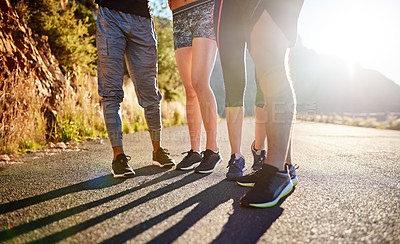 Buy stock photo Cropped shot of a fitness group out for a run together