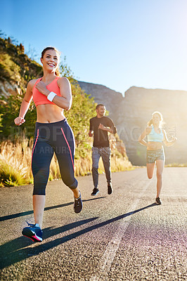 Buy stock photo Shot of a fitness group out for a run together