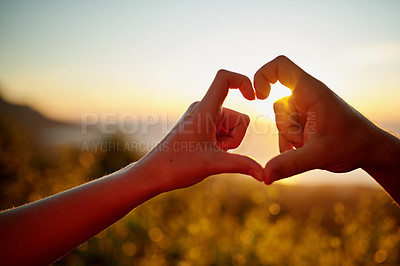 Buy stock photo Cropped shot of a couple forming a heart shape with their hands outside