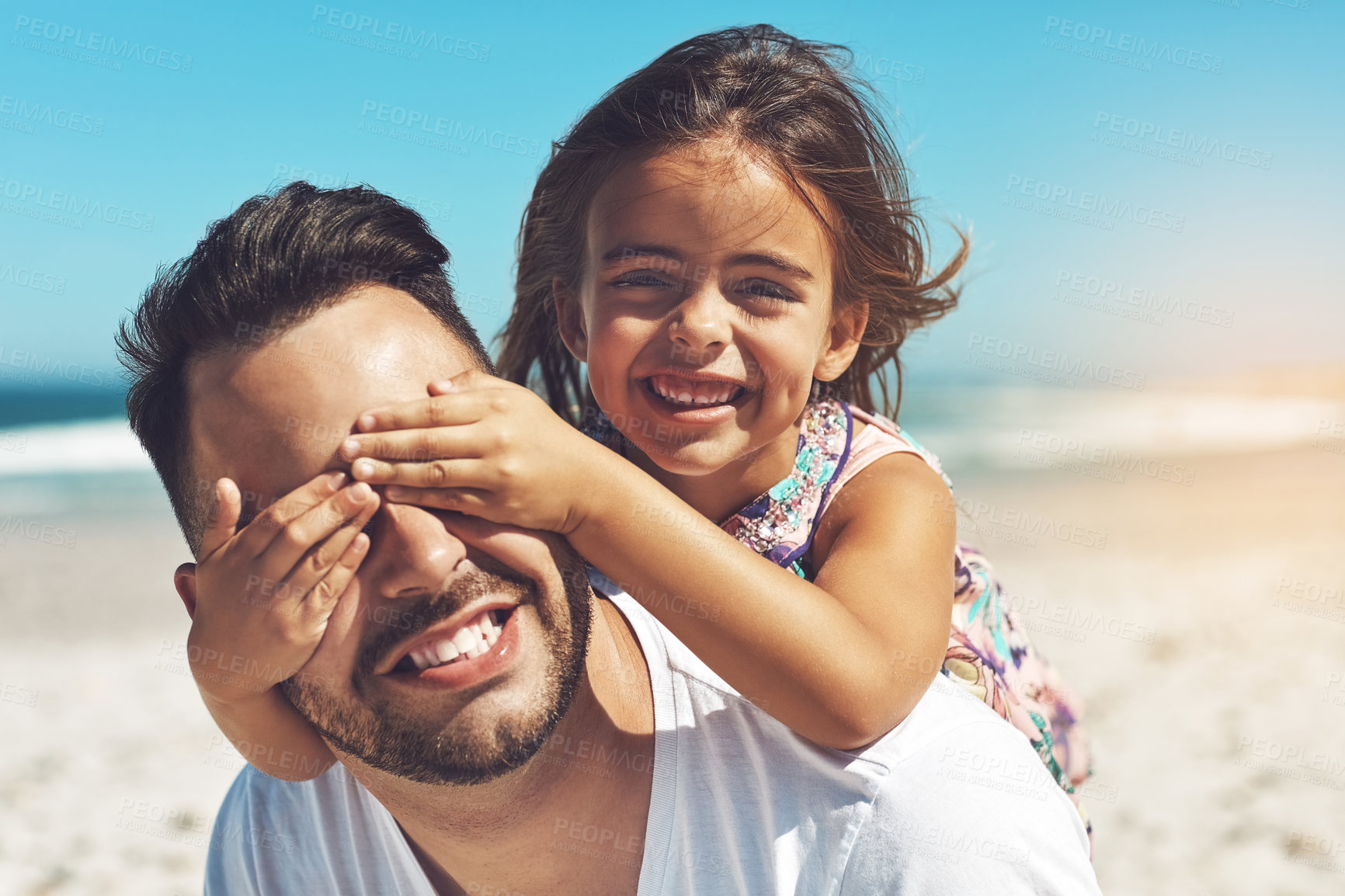Buy stock photo Cropped shot of a young father and his daughter enjoying a day at the beach
