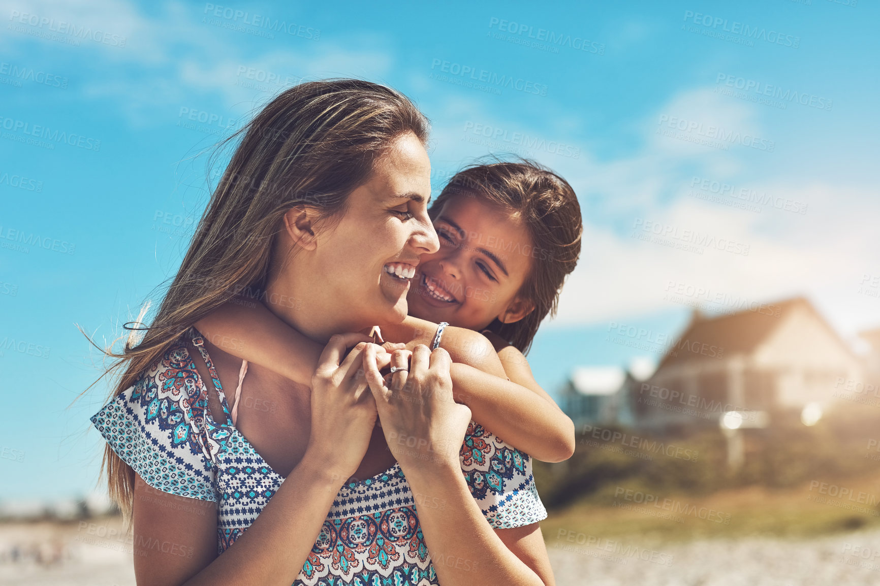 Buy stock photo Cropped shot of a young mother and her daughter enjoying a day at the beach