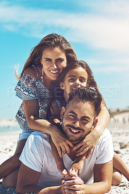 Buy stock photo Cropped portrait of a happy young family enjoying their day at the beach