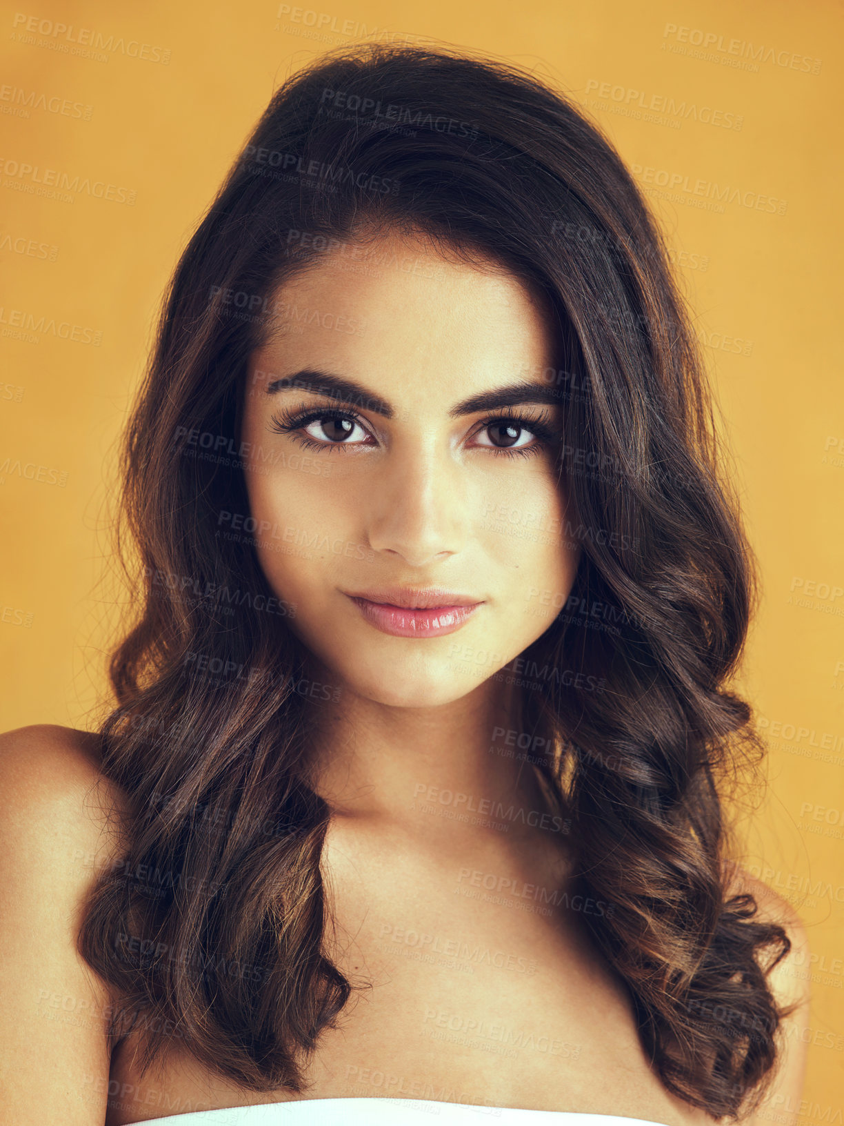 Buy stock photo Cropped shot of a beautiful young woman posing in the studio