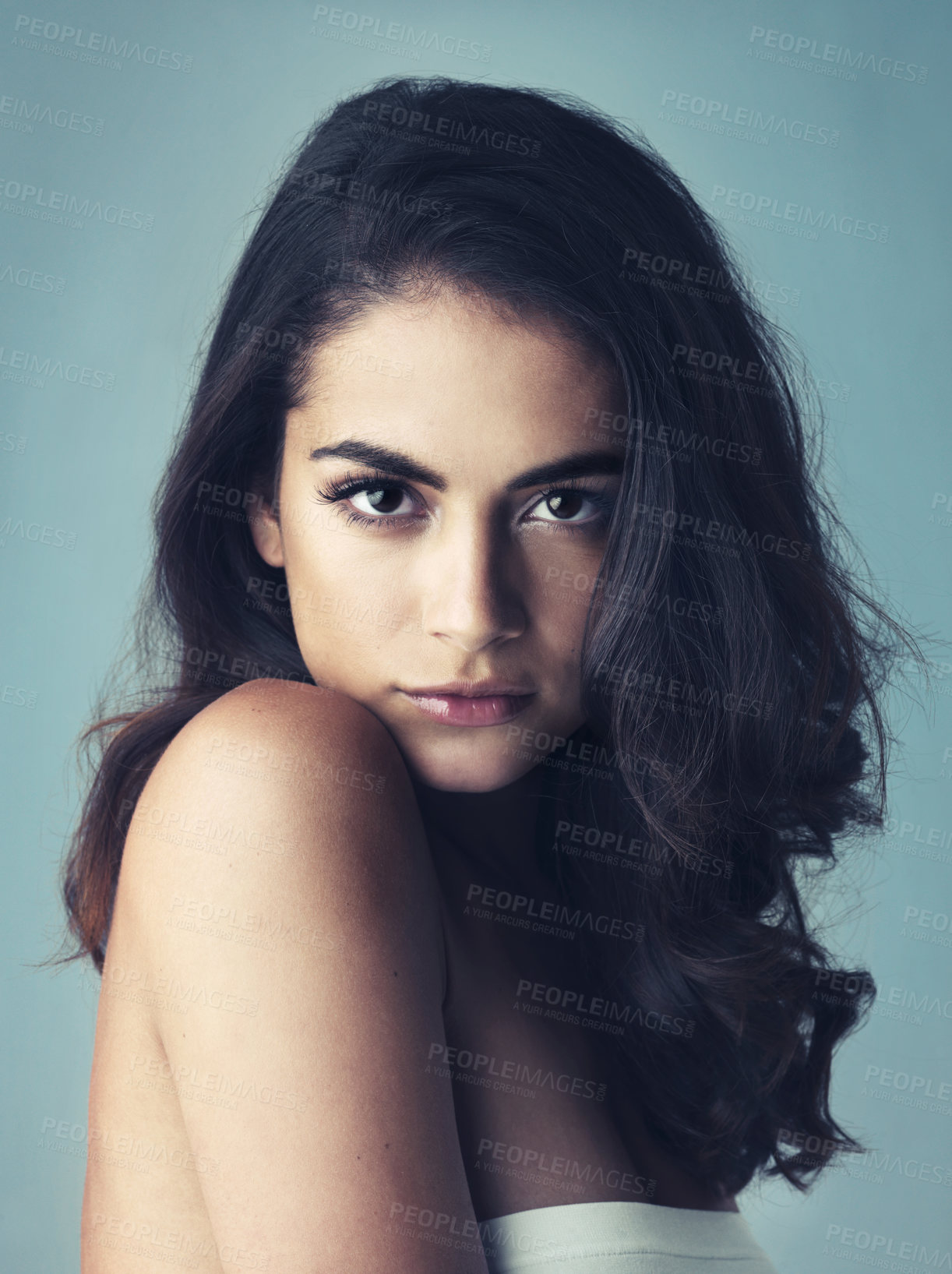 Buy stock photo Cropped shot of a beautiful young woman posing in the studio