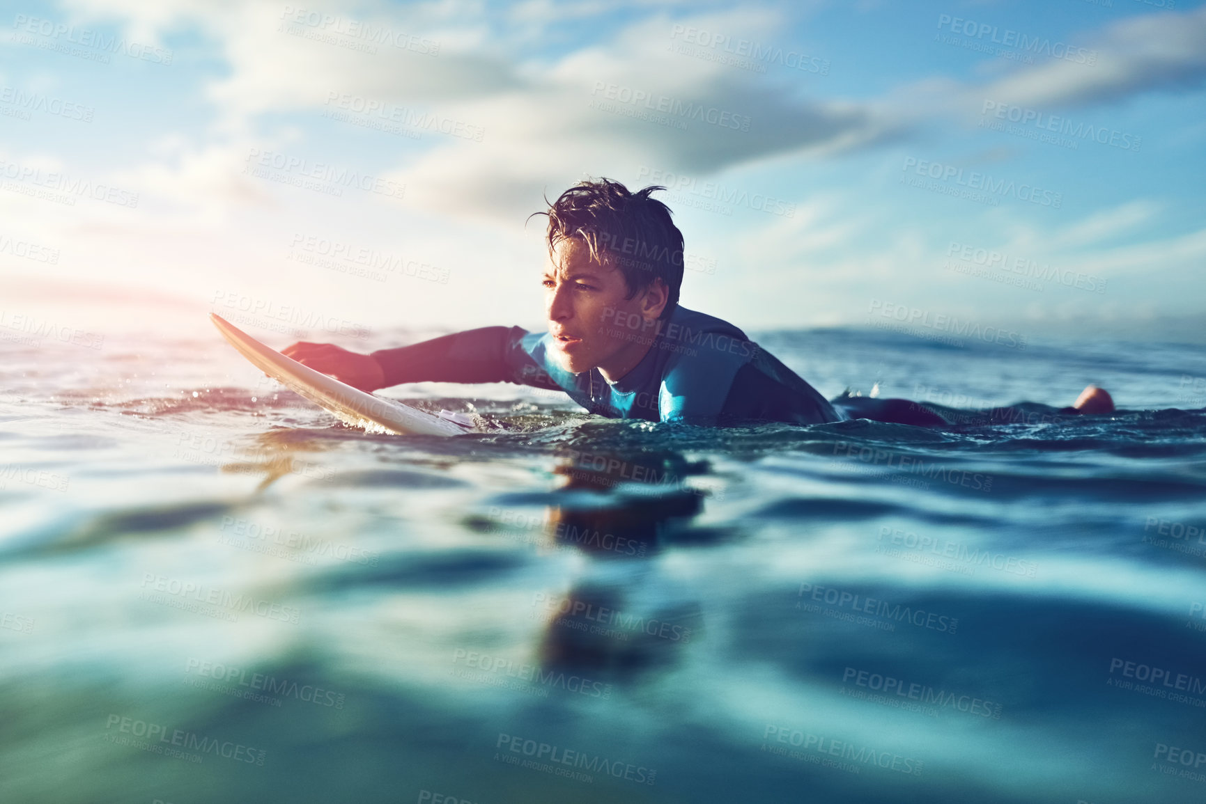 Buy stock photo Kid, ocean and surfing in water for holiday, sports and wellness with board, blue sky and swimsuit. Boy, sea and swimming at beach as surfer for waves, fitness and summer workout while on vacation