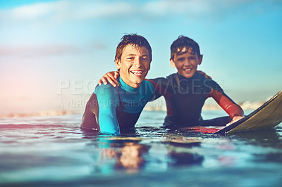 Buy stock photo Shot of two young boys out surfing