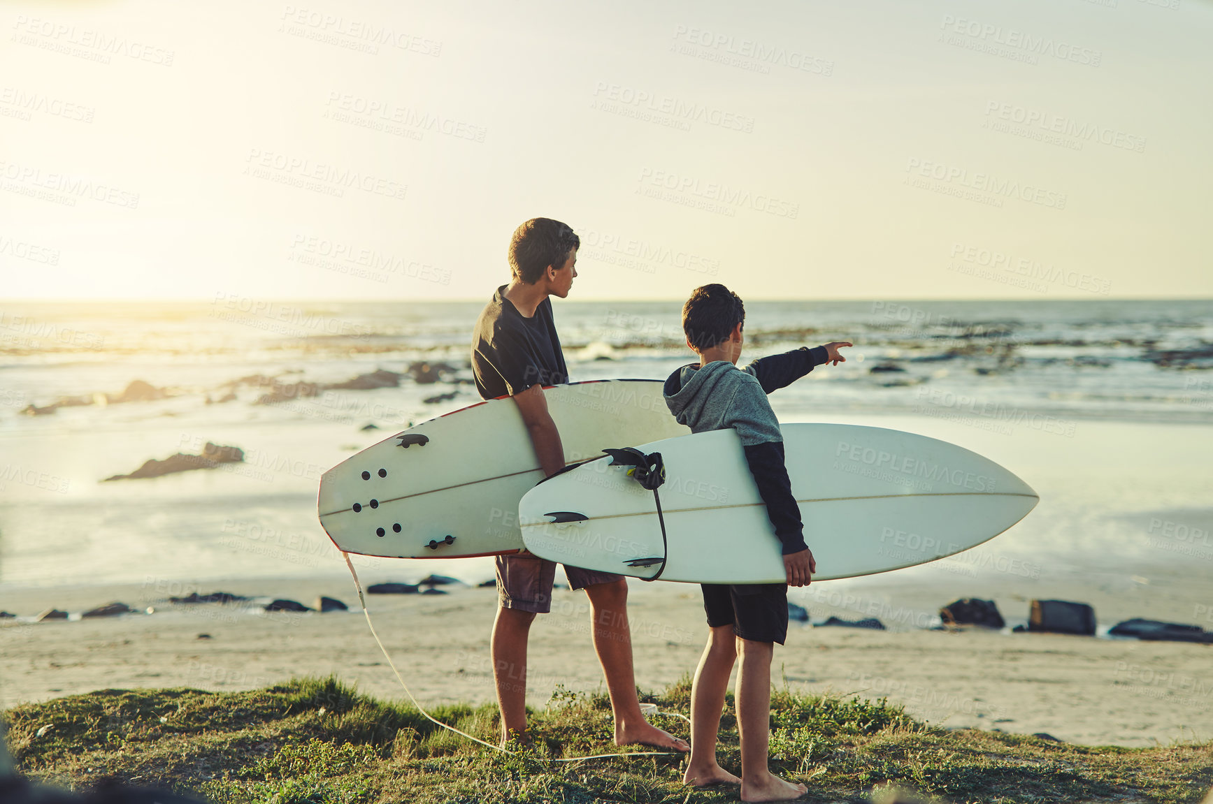 Buy stock photo Learning, surf and kids on beach with board for adventure on vacation, holiday or sport in water. Child, surfer and search the current in waves for safety on island in summer, pointing or teens relax