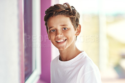 Buy stock photo Portrait of a cheerful little boy standing outside an ice-cream shop by the beach