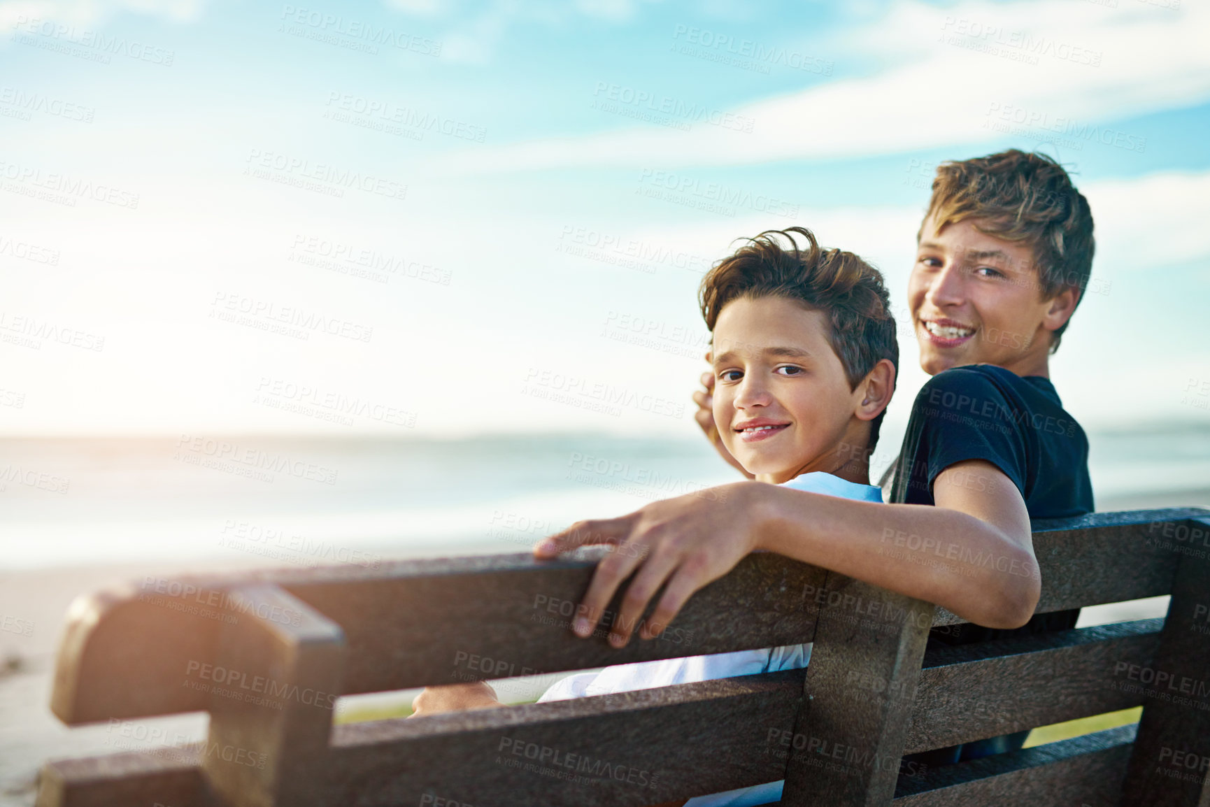 Buy stock photo Portrait, children and brothers hug on beach bench at sunset with care, trust and bonding on vacation together. Ocean, travel or face of kid siblings at sea on adventure, journey or Istanbul trip