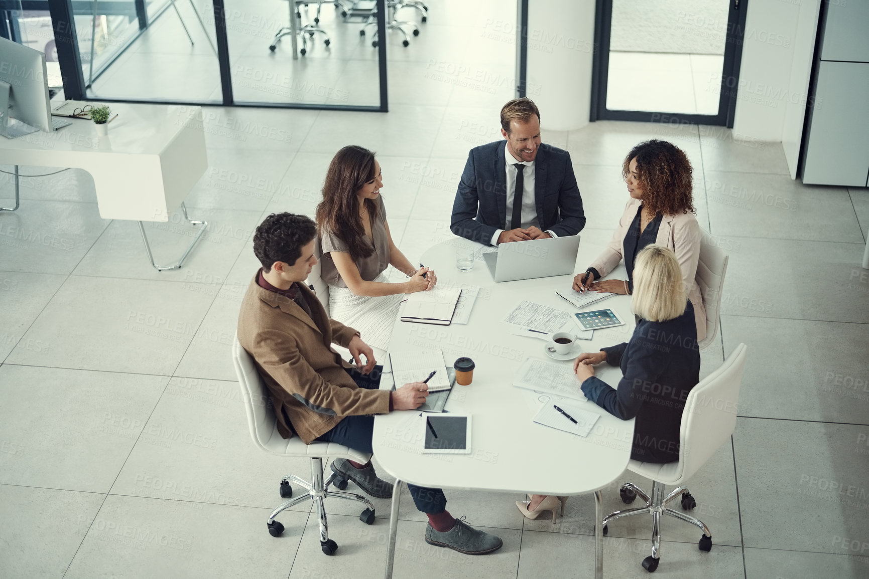 Buy stock photo Shot of a team of colleagues having a meeting in a modern office