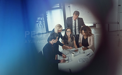Buy stock photo Shot of a group of colleagues using digital tablet together during a meeting in a modern office