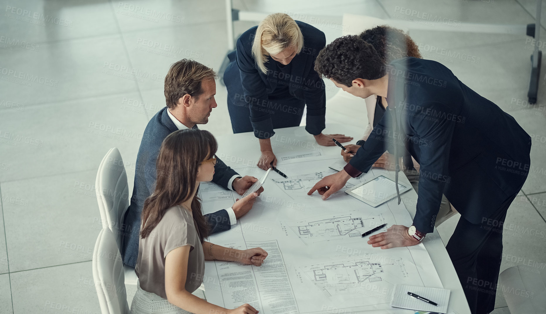 Buy stock photo Shot of a team of corporate architects collaborating on a plan in a modern office