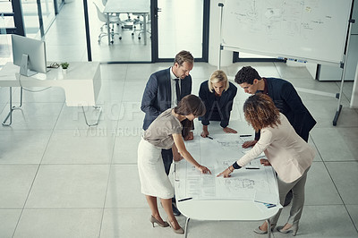 Buy stock photo Shot of a team of corporate architects collaborating on a plan in a modern office