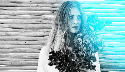 Buy stock photo Black and white shot of an attractive young woman holding a bunch of fresh flowers