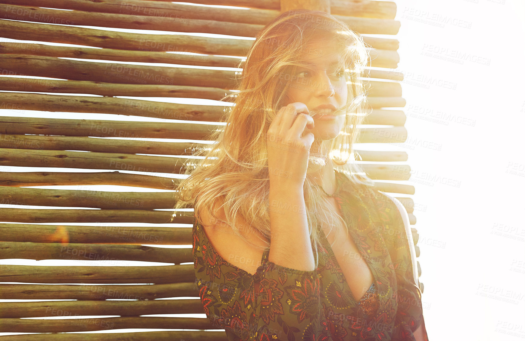 Buy stock photo Cropped shot of a fashionable young woman posing against a wooden partition