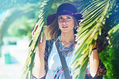 Buy stock photo Portrait of a beautiful young woman standing amongst palm tree leaves