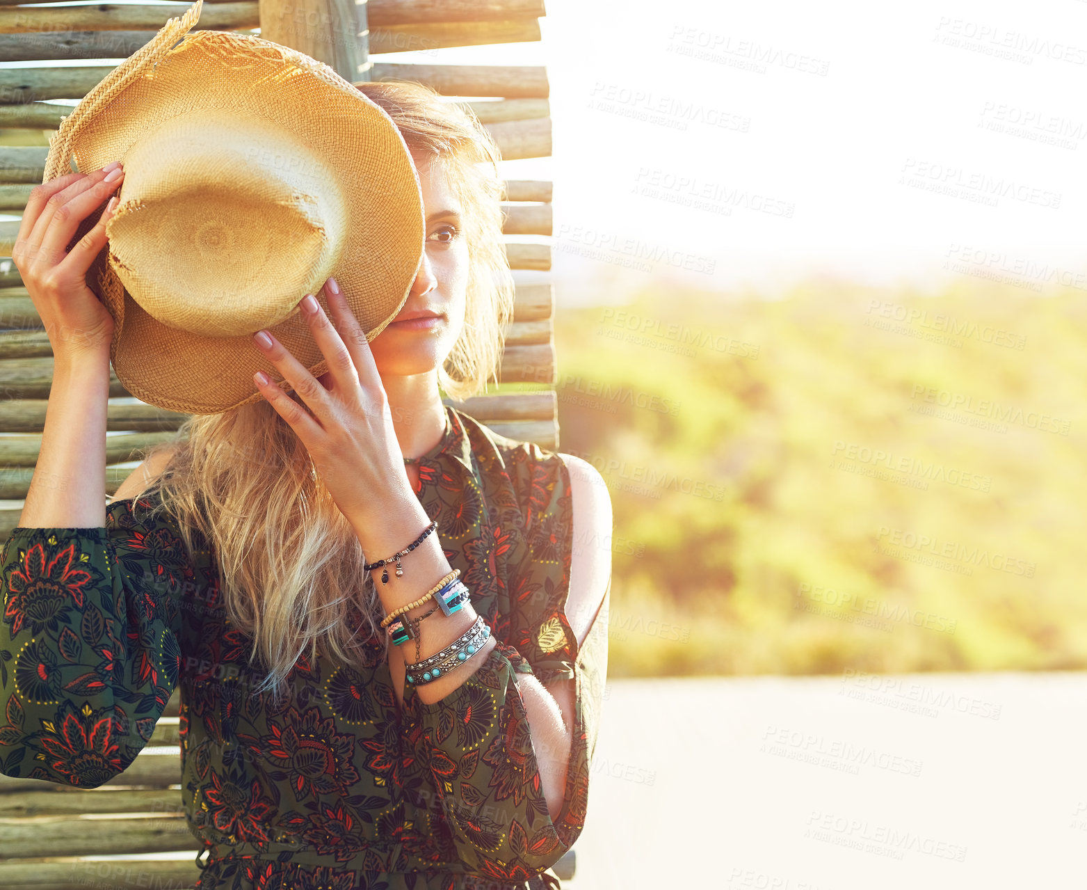 Buy stock photo Cropped shot of a young woman holding a hat over her face