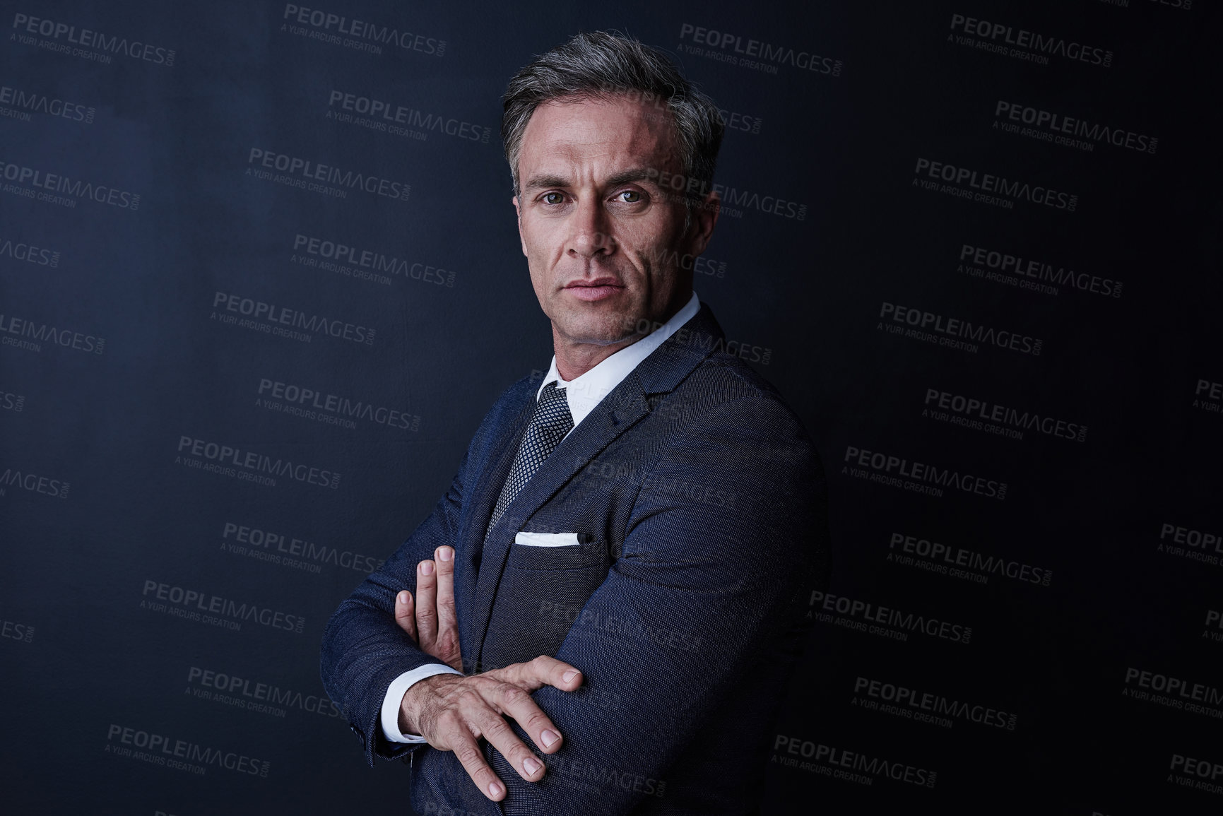 Buy stock photo Studio portrait of a confident and mature businessman standing against a dark background