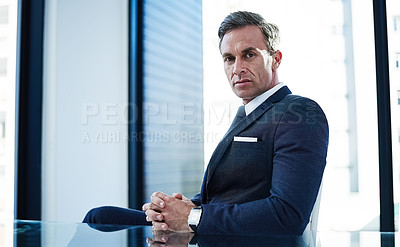 Buy stock photo portrait of a successful businessman sitting at his desk in an office