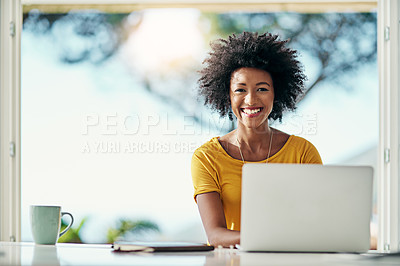 Buy stock photo Cropped portrait of an attractive young woman working on her laptop at home