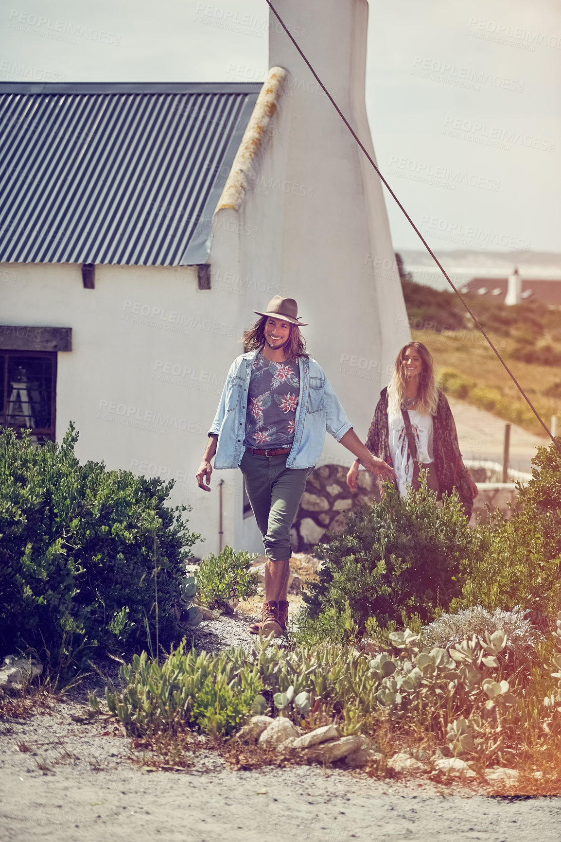 Buy stock photo Shot of an adventurous young couple exploring a small town together on a weekend getaway