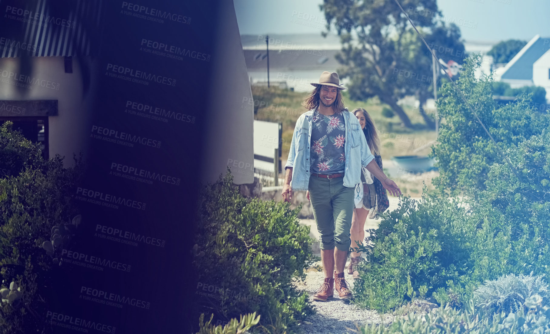 Buy stock photo Shot of an adventurous young couple exploring a small town together on a weekend getaway