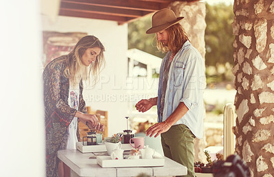 Buy stock photo Shot of a free spirited young couple enjoying coffee together at a roadside shop