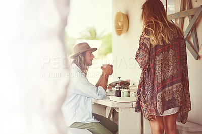 Buy stock photo Shot of a free spirited young couple enjoying coffee together at a roadside shop
