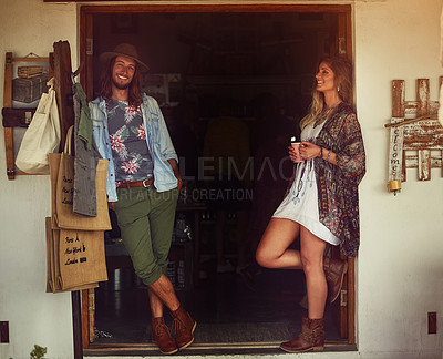 Buy stock photo Shot of an affectionate young couple posing outside a roadside shop