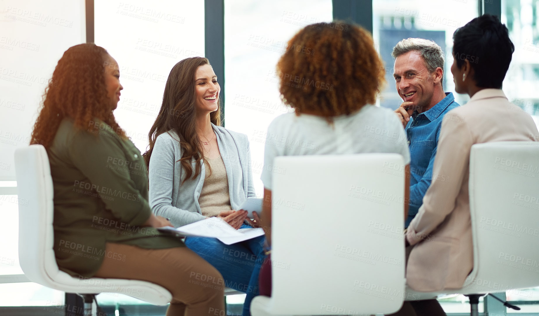 Buy stock photo Shot of a team of colleagues having a meeting in a modern office